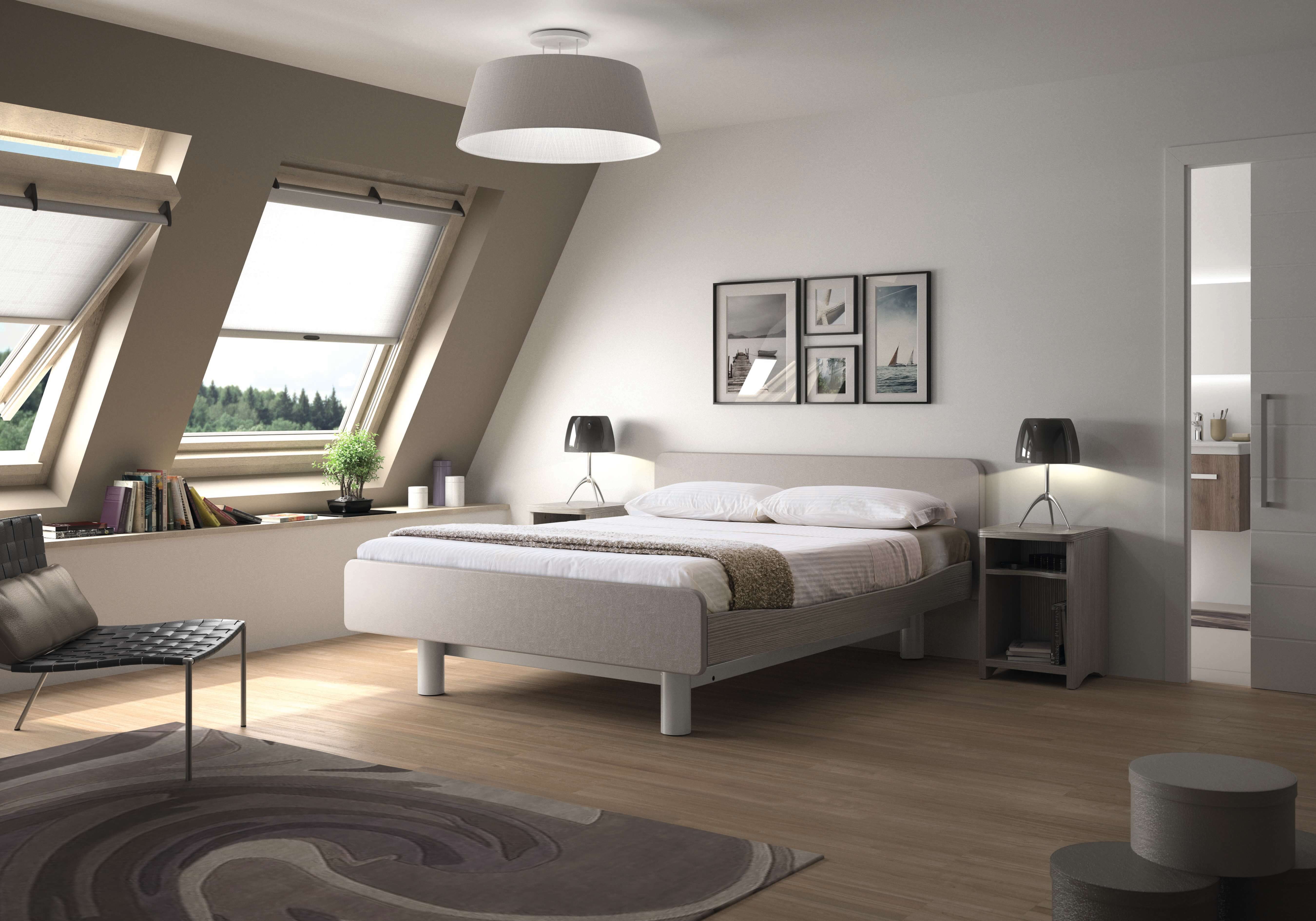 Image of a double-sized adjustable bed in a bedroom with open windows.