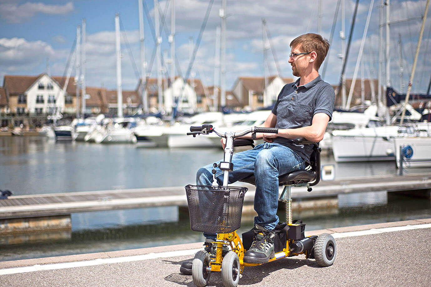 Man on mobility scooter by waterside