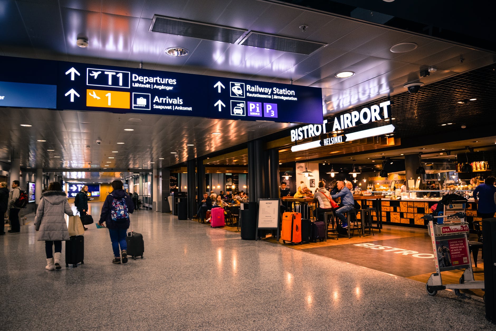 A busy airport, with cafe in background