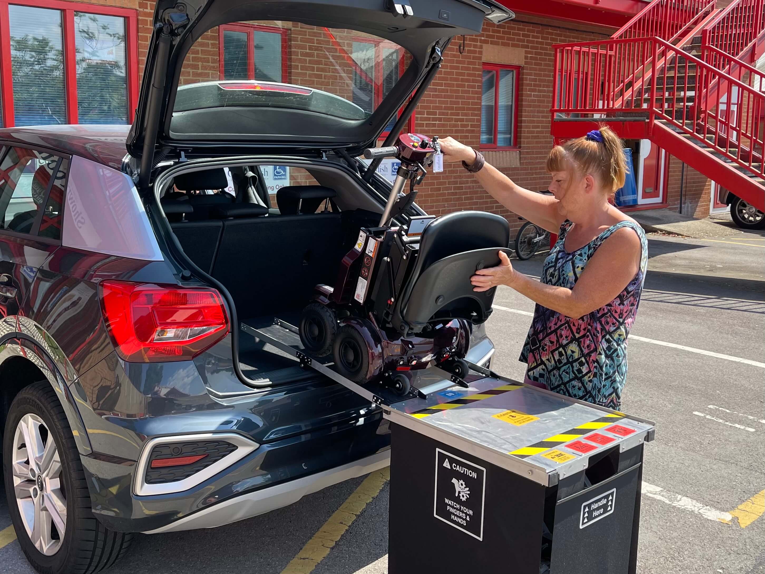 Loading a scooter into back of car using hoist