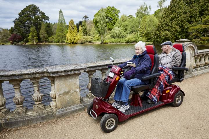 Visitors in a mobility scooter at Sheffield Park and Garden, East Sussex. National Trust Images/Arnhel de Serra